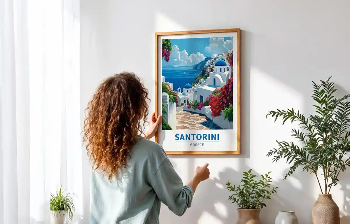 Framed seascape and shoreline artwork arranged on a light-toned wall in a sunlit room