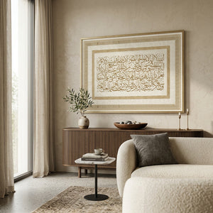 The gold-border Ayat Al-Kursi canvas above a fluted console and a boucle armchair